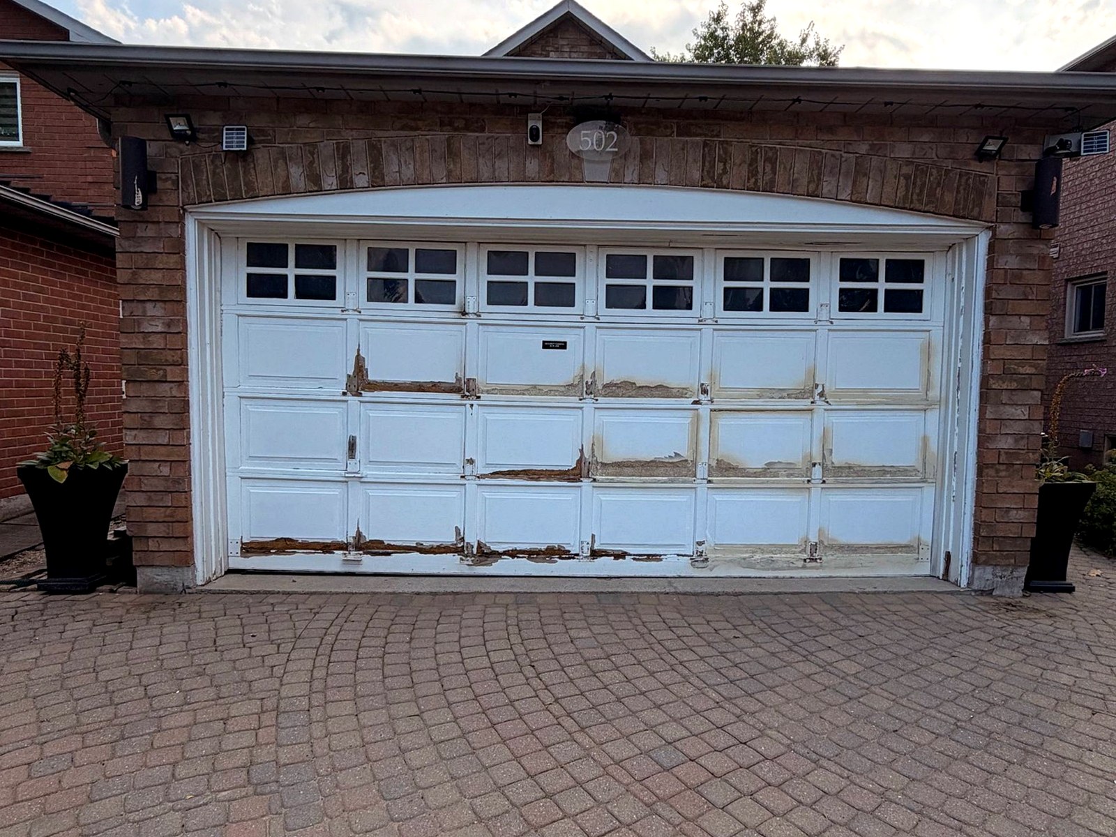 Before: old rusted garage door before replacement