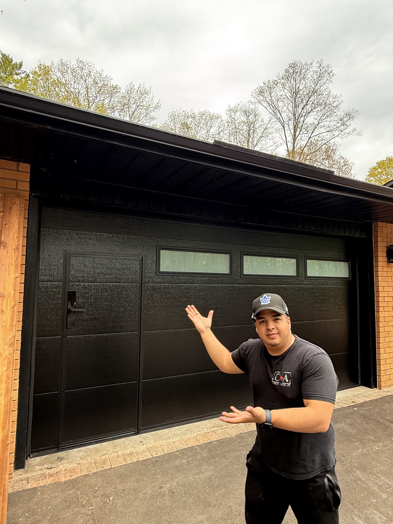 Black walk-through garage door with CA Garage Doors technician