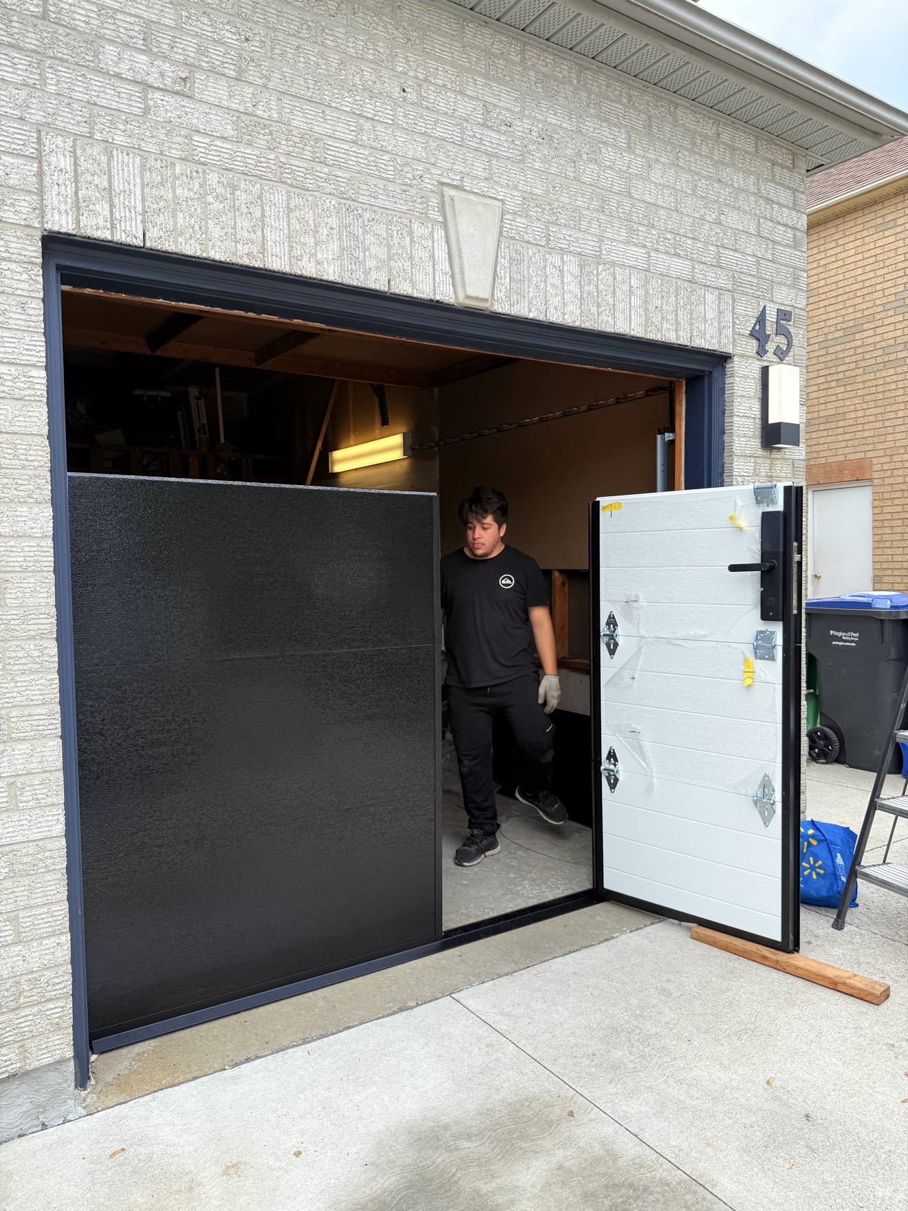 Walk-through pedestrian door hinged during assembly